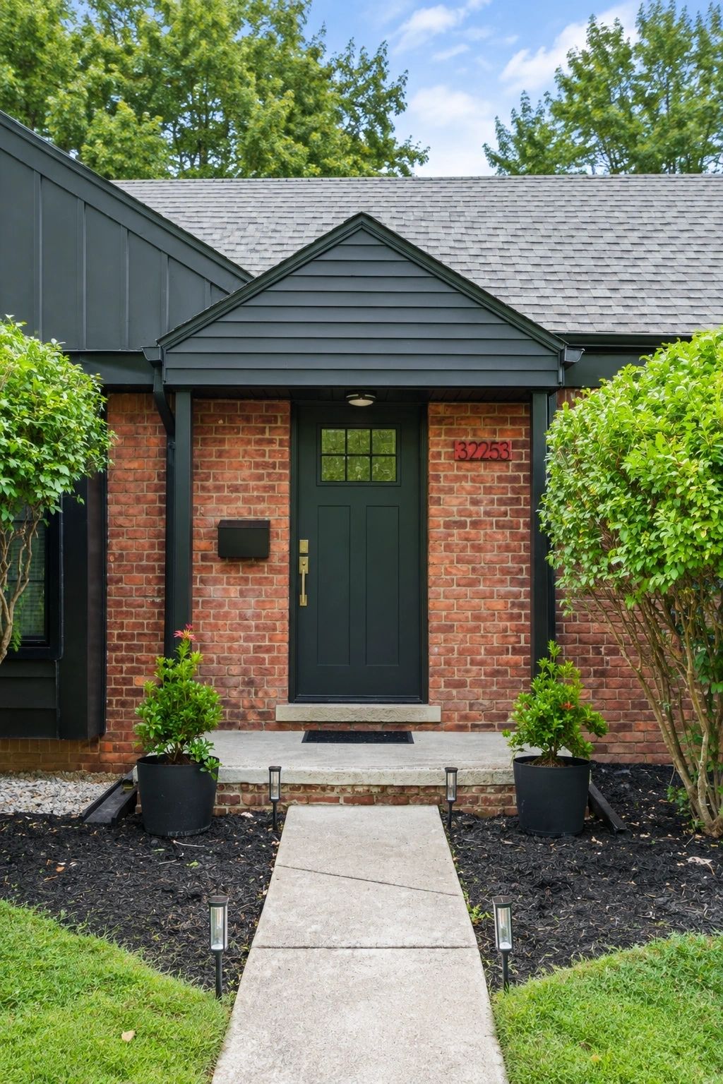 Modern residential home exterior with red brick facade